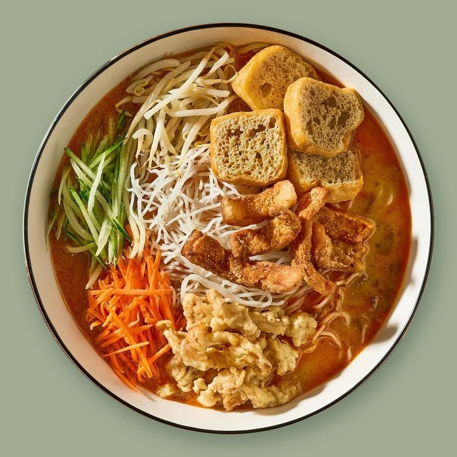 A bowl of Savor Sarawak laksa with tofu puffs and bean sprouts