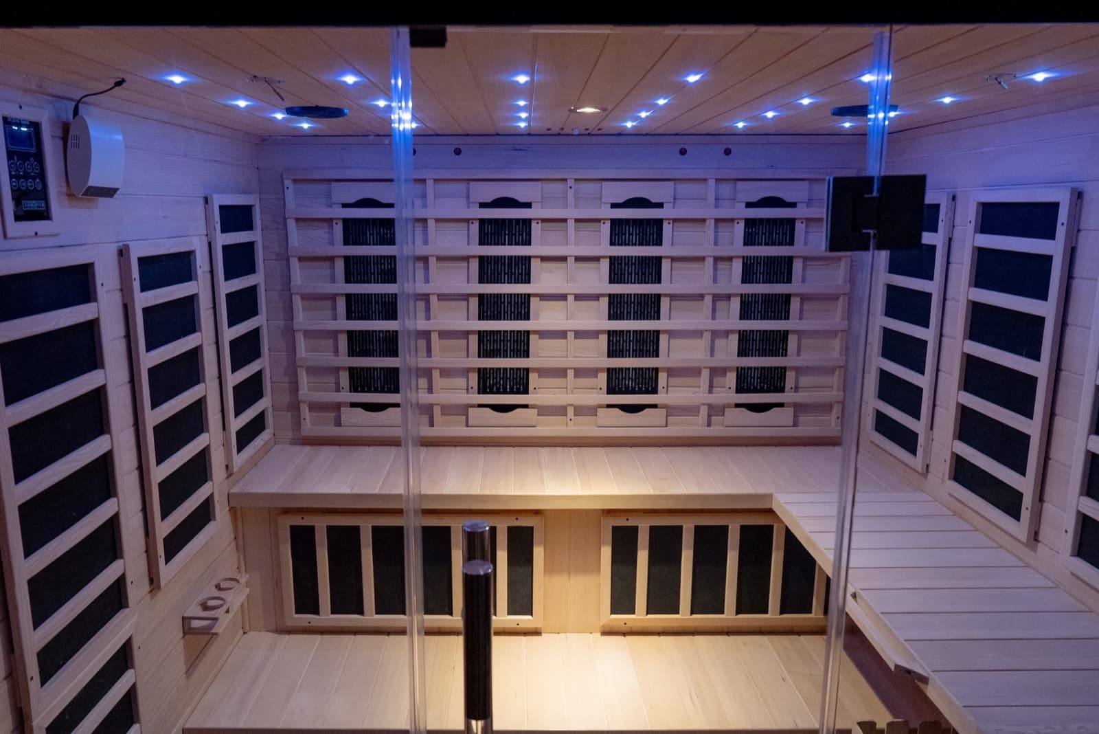 The infrared sauna at Savor Wellness, with pale timber benches and soft ceiling lights